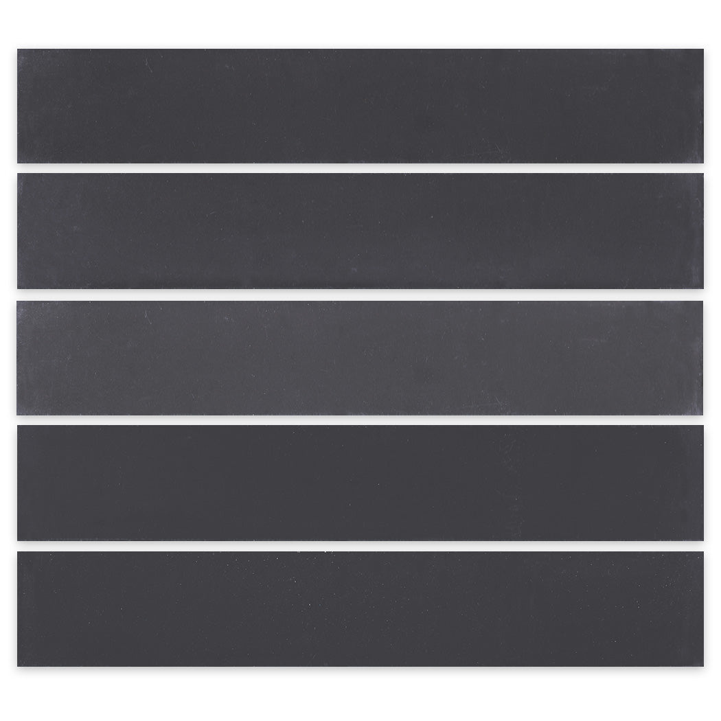 Five 2x12 Solid Black tiles by New York Cement Tile arranged in parallel rows on a white background.