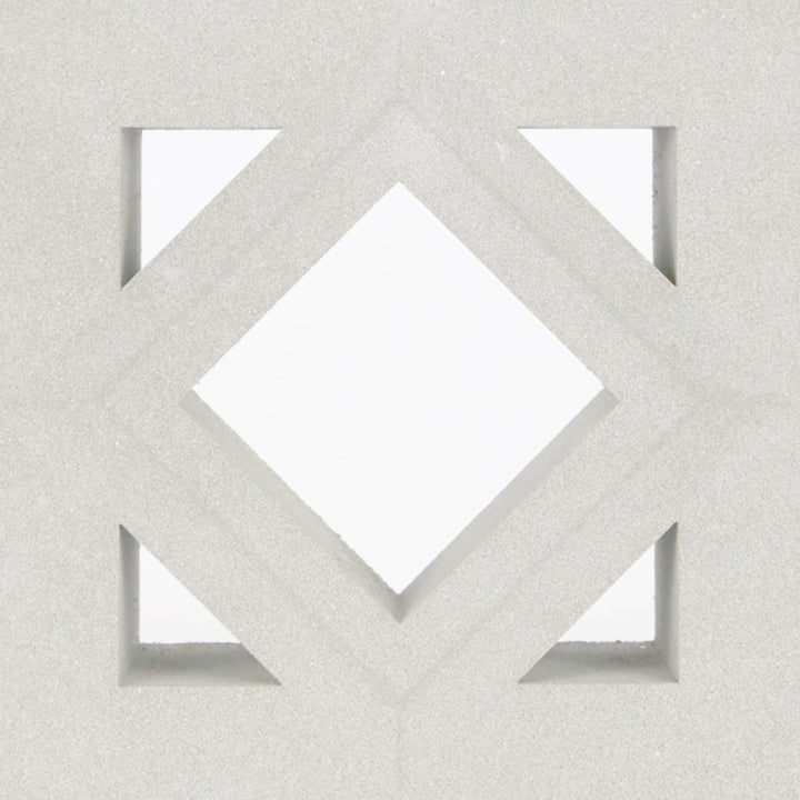 Antil Sample by New York Cement Tile: white geometric diamond and triangle pattern on light gray, mid-century modern style.
