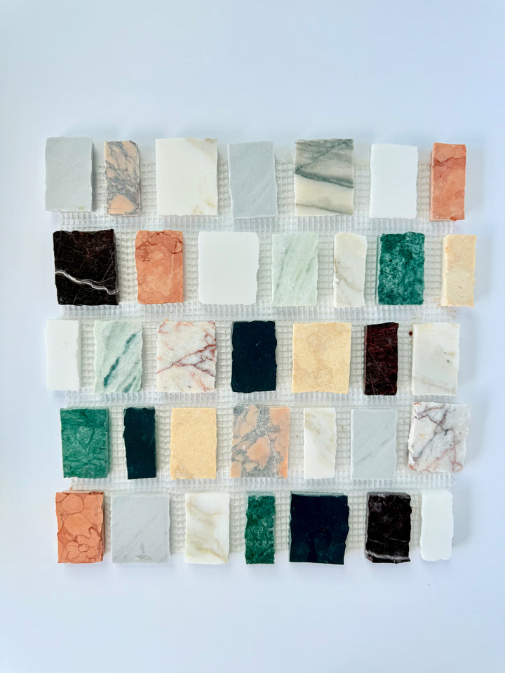 Rectangular samples of Scarpa I Multicolors Dark Mosaic Marble Mesh by New York Cement Tile on a white background.