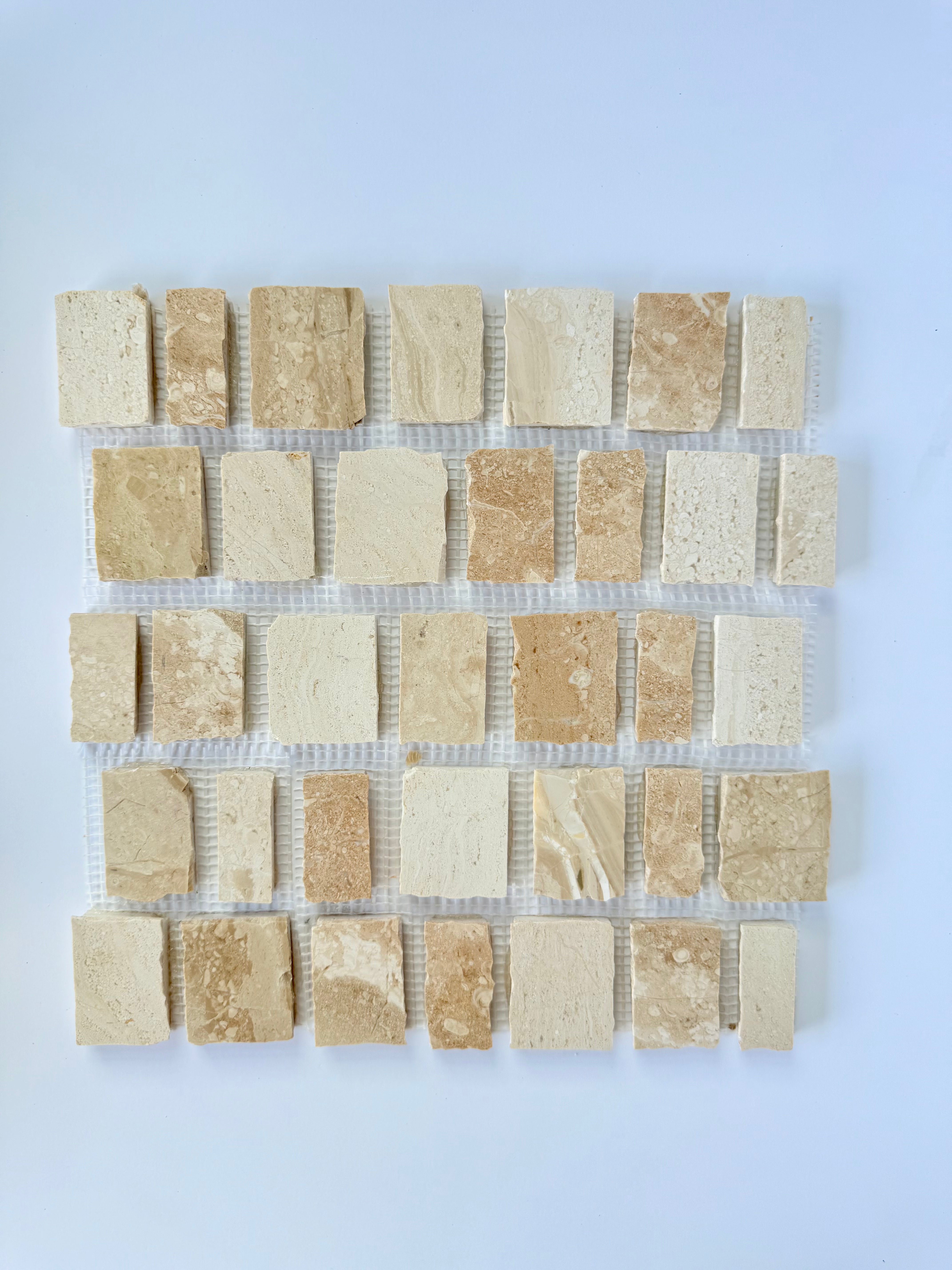Scarpa I Golden Desert Mosaic Marble Mesh by New York Cement Tile, beige and cream tiles shown on a white background.