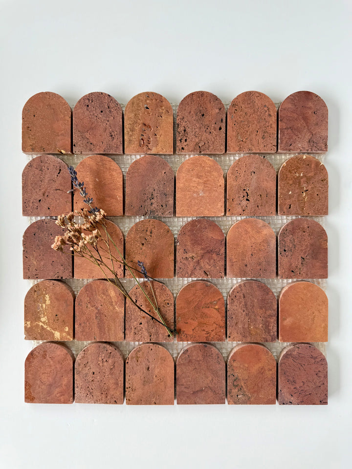 Scarpa I Red Travertine Arch Mosaic by New York Cement Tile features arched tiles in a grid, inspired by the Mesh Collection.