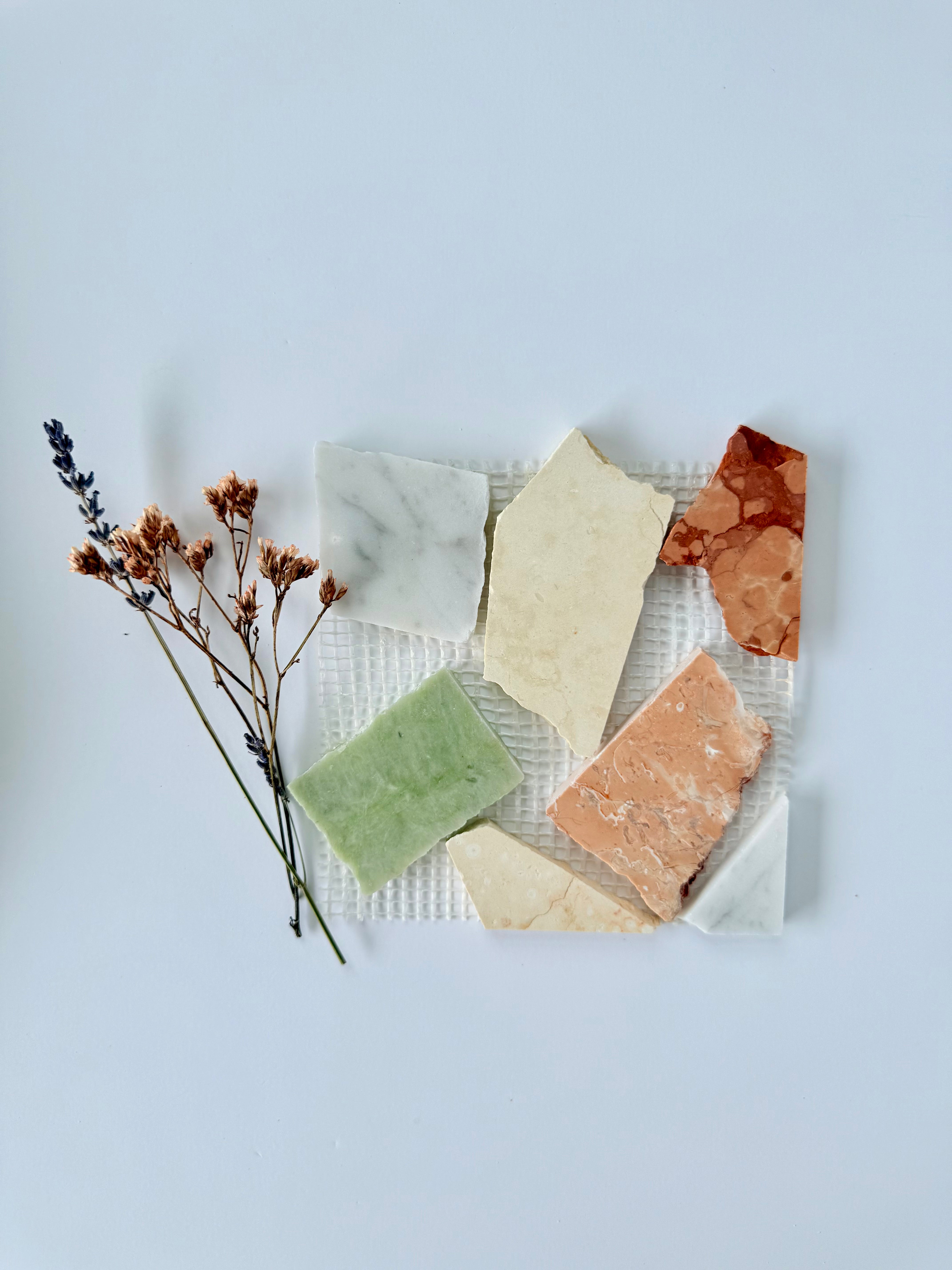 Candy - Puzzle stone tiles by New York Cement Tile, Italian-inspired colors and dried flowers on white background.