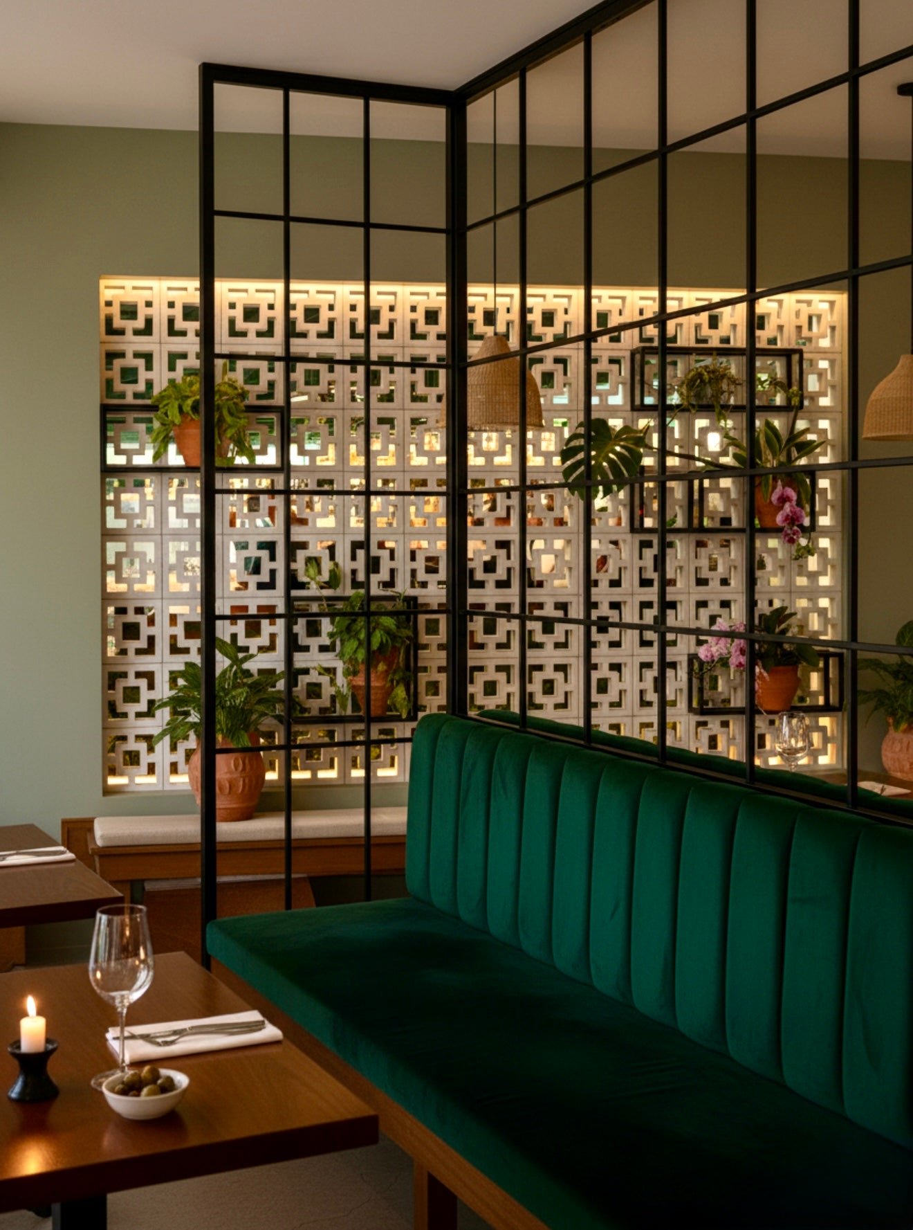 Tong by New York Cement Tile features green velvet seats, candle-lit tables, and patterned glass-partition walls.