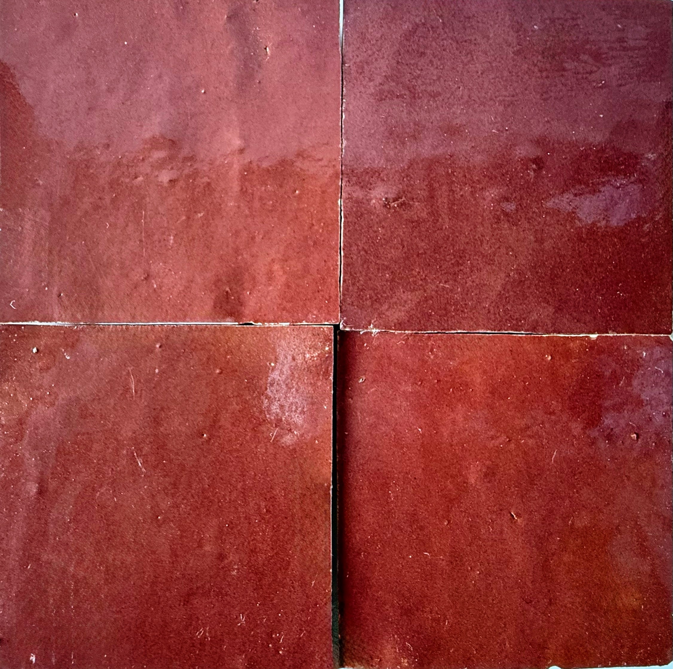 Four Chocolate Cherry tiles by New York Cement Tile arranged in a grid with visible grout lines.