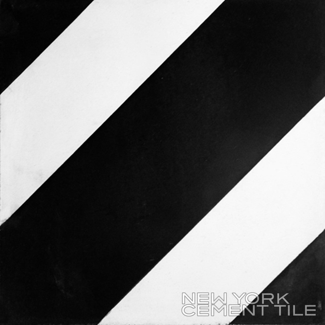 Black and white N20-232, Extra Sample tile by New York Cement Tile with diagonal stripes and branded text in the corner.