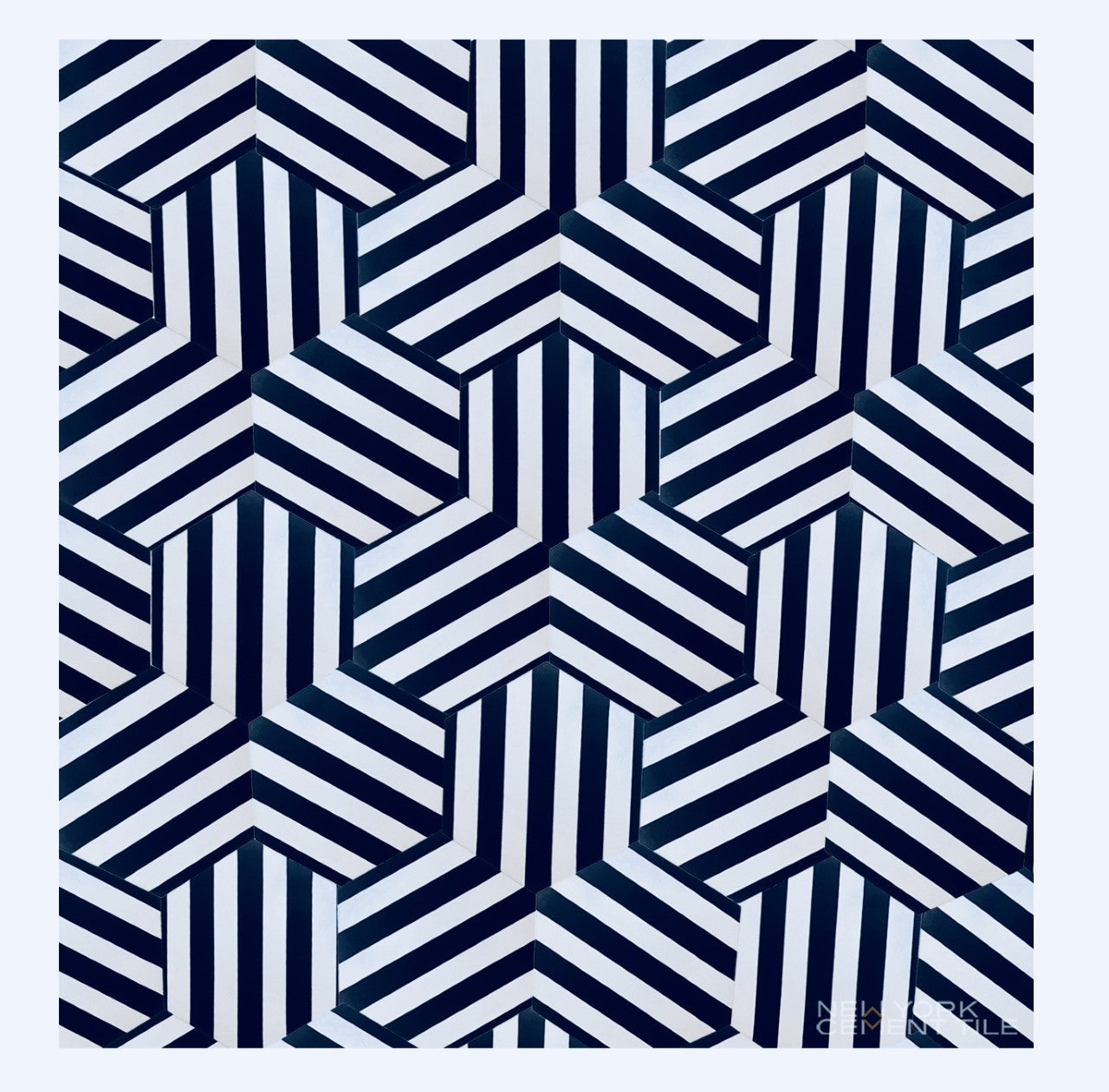 NH23-22 by New York Cement Tile features black, white, and gray hexagons and stripes for a striking optical illusion effect.