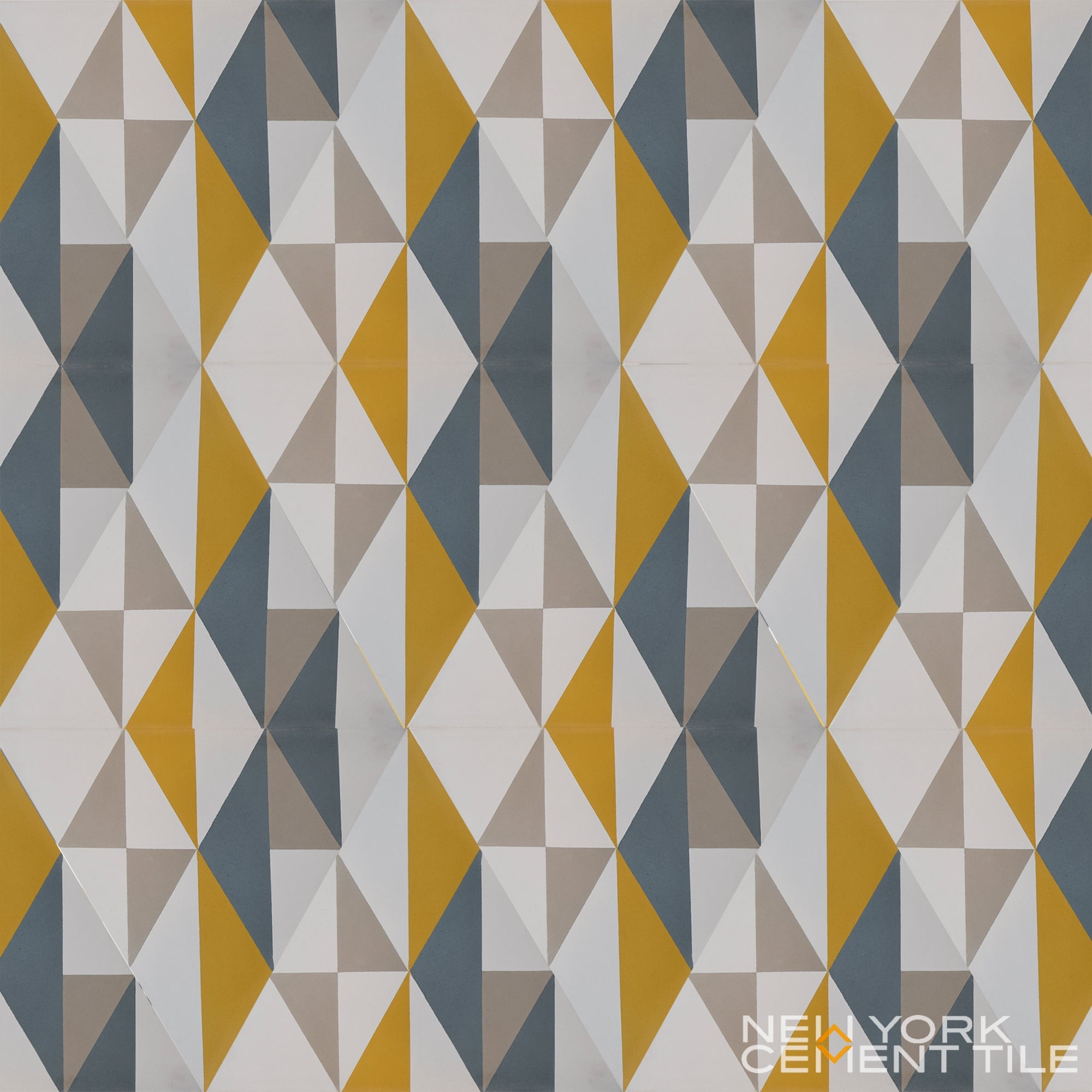 NLT-12A tile sample from New York Cement Tile: geometric pattern in yellow, gray, blue & white. Brand logo in corner.