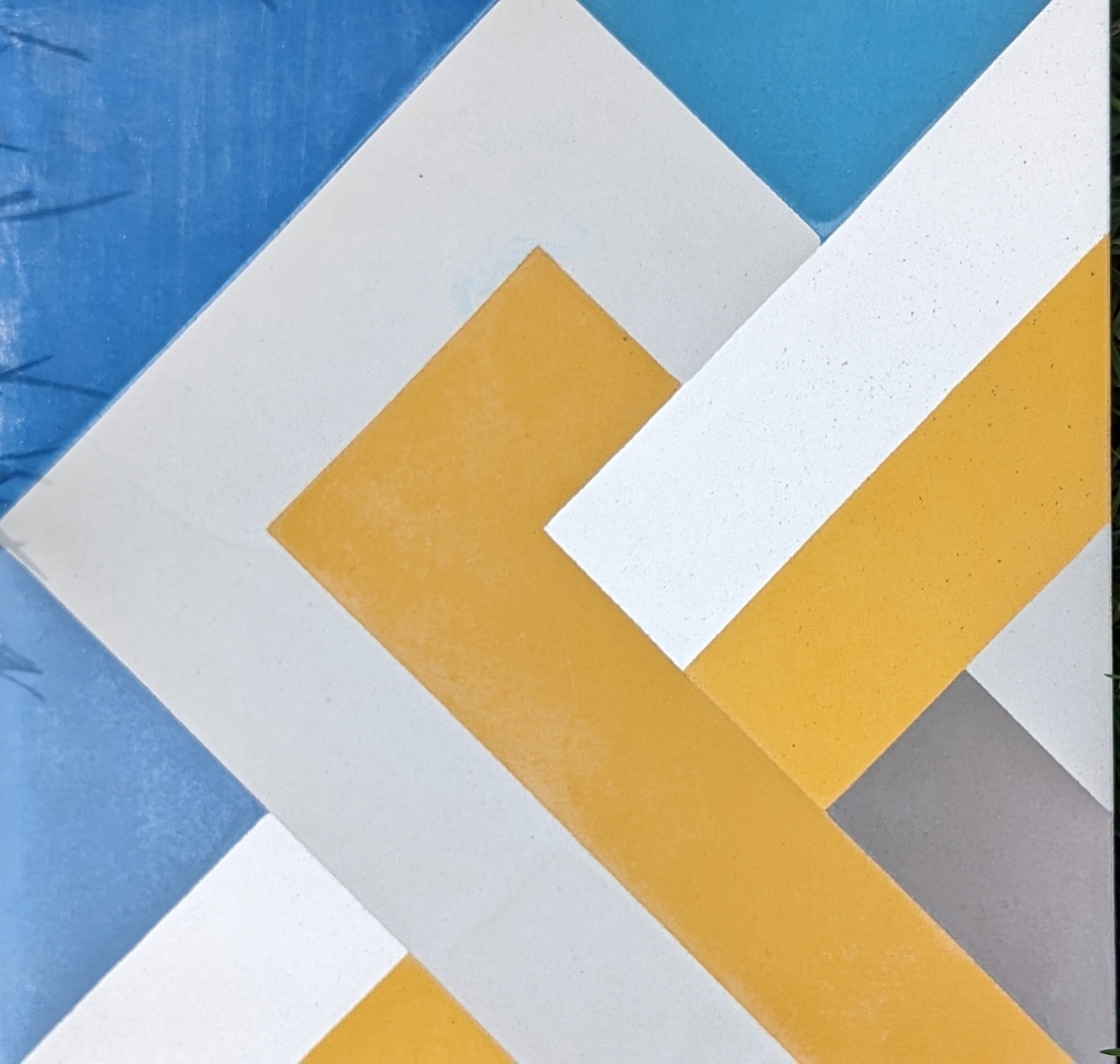Geometric abstract art with NL20-1A customizable tiles by New York Cement Tile in yellow, white, gray on blue background.