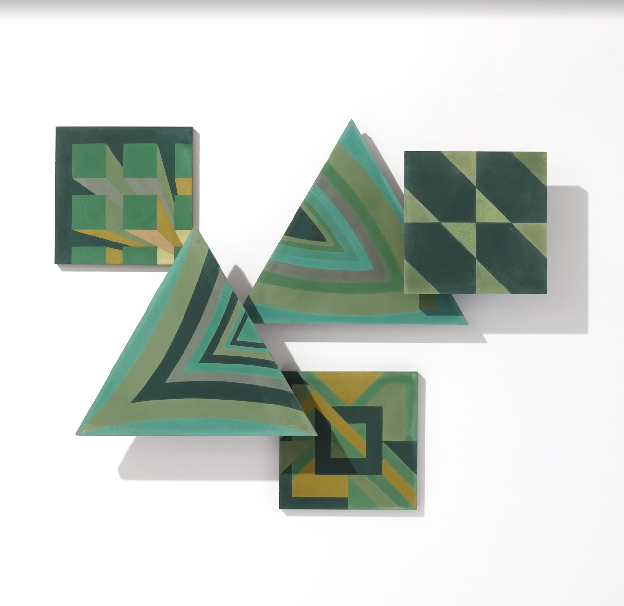 Four green NL20-2A tiles by New York Cement Tile overlap, forming pop art stripes, blocks, and diagonal lines.