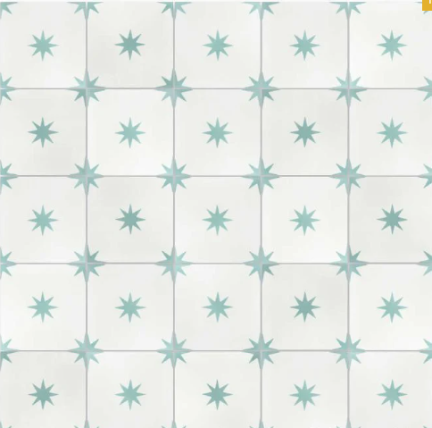The Pleiades A In Sea Glass sample by New York Cement Tile features a durable, geometric star pattern in white and light blue.