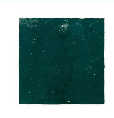 Aurora by New York Cement Tile: a square, dark green Zellige tile with slight texture and scattered small specks.