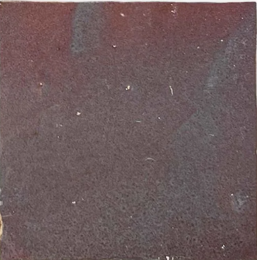 A square, dark, coarse Thistle sample from New York Cement Tile, with minor scratches, like handcrafted Zellige tile.