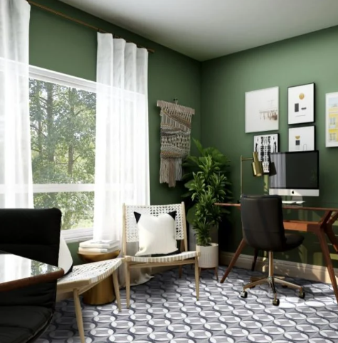 A stylish home office with green walls, modern furniture, a computer desk, plants, and Petalos Pebble Terrazzo tiles by New York Cement Tile.