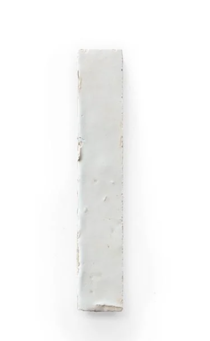 A Slim Glazed Ivory Cloud (5½"x⅞") sample by New York Cement Tile on a plain white background.