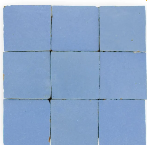 Nine “Grape” tiles by New York Cement Tile arranged 3x3 with slight gaps between some of the blue tiles.