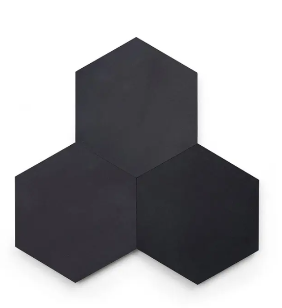 Three New York Cement Tile Solid Hex-Black tiles are arranged in a honeycomb pattern with one on top and two below.