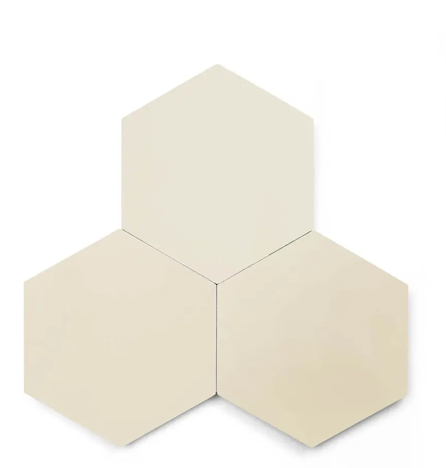 Three Solid Hex- Sand tiles by New York Cement Tile arranged in a cluster on a white background.