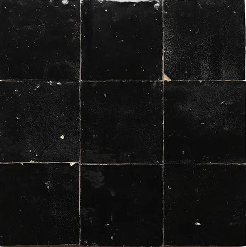 Nine Black Onyx tiles by New York Cement Tile in a 3x3 grid, with chipped edges and textured surface for durable flooring.