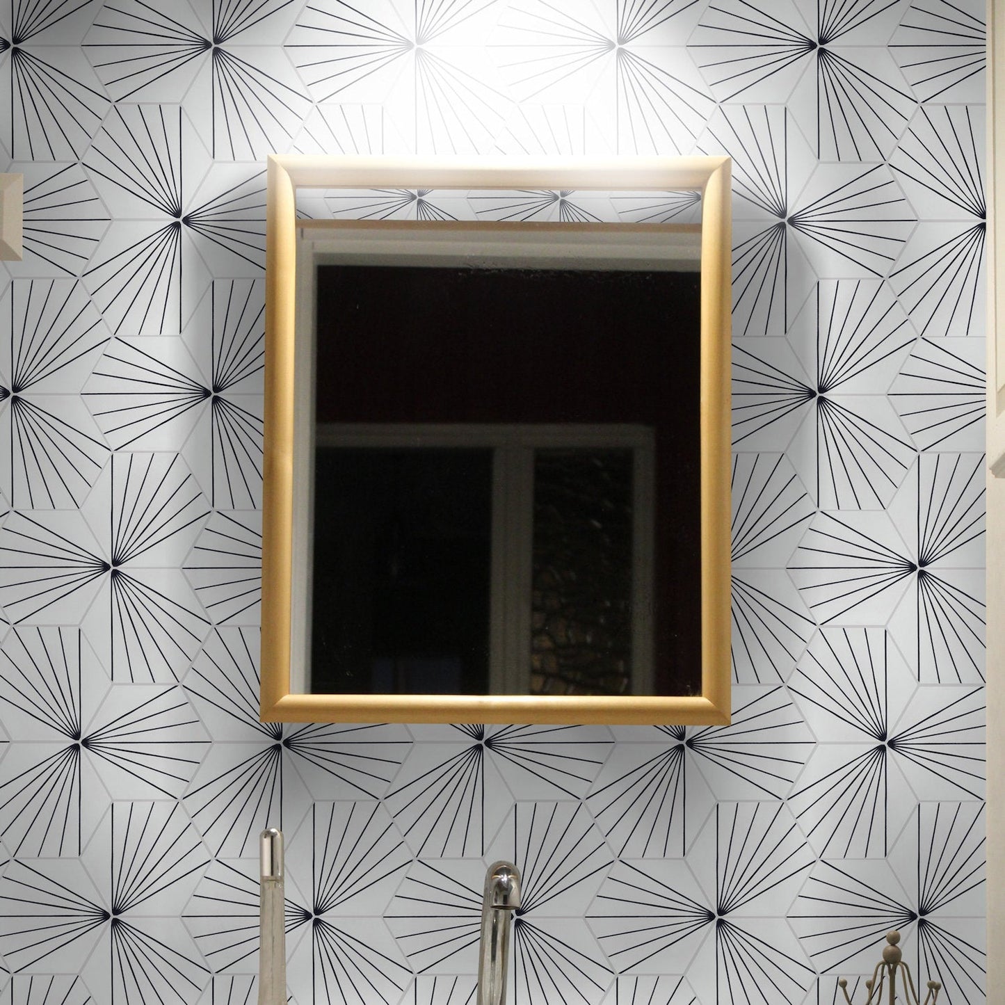 A NH23-036 White tile by New York Cement Tile adds geometric flair to a wall above a silver faucet and gold mirror.