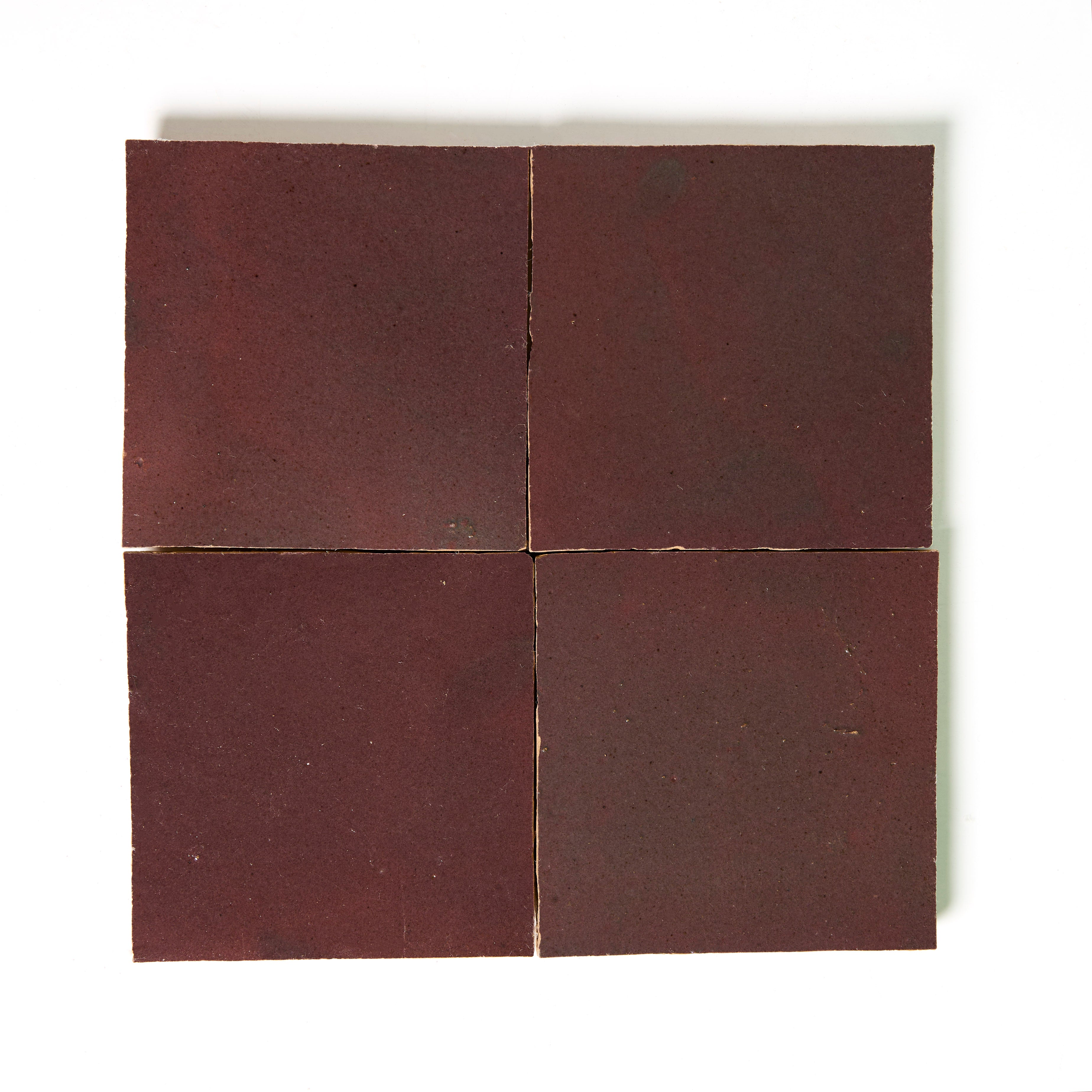 Four Thistle square tiles by New York Cement Tile in reddish-brown, arranged in a grid on white.