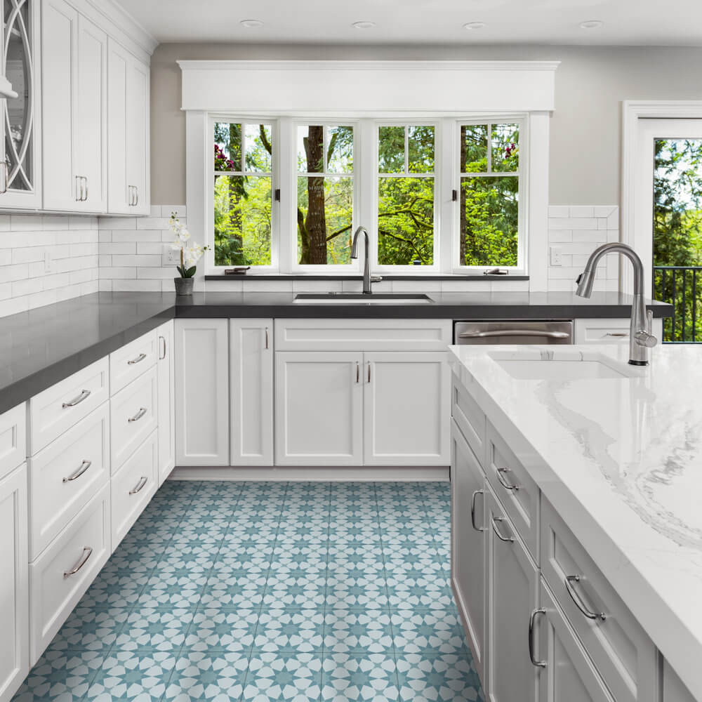 Modern kitchen with white cabinets, gray counters, N20-271 Blue tiles by New York Cement Tile, plus large windows.
