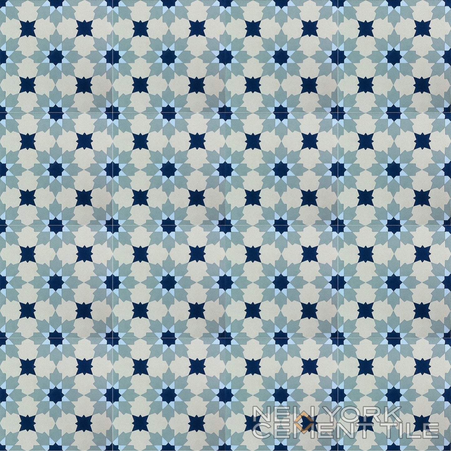 Blue, gray & white geometric star tile (N20-028, Sample) by New York Cement Tile; brand in bottom right corner.