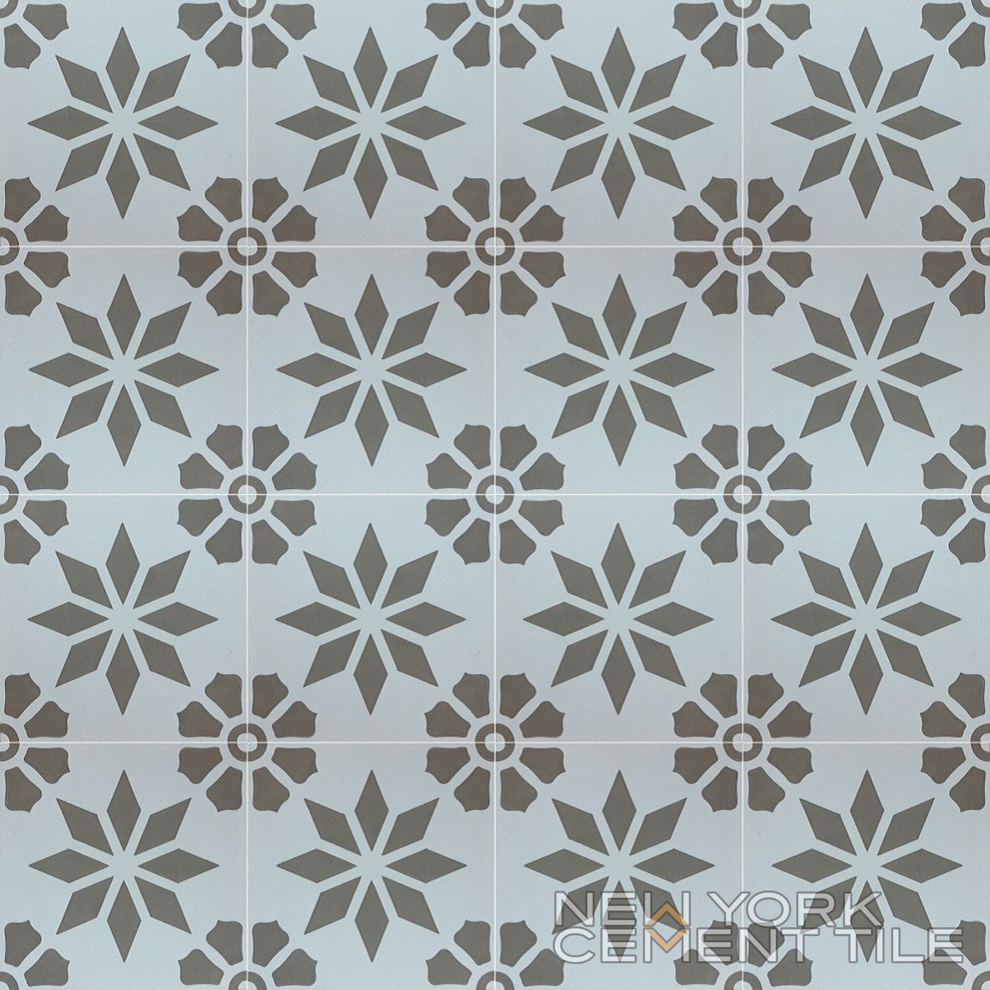 N20-152 by New York Cement Tile: cement tiles with dark star and flower motifs on a light background in a handcrafted grid.