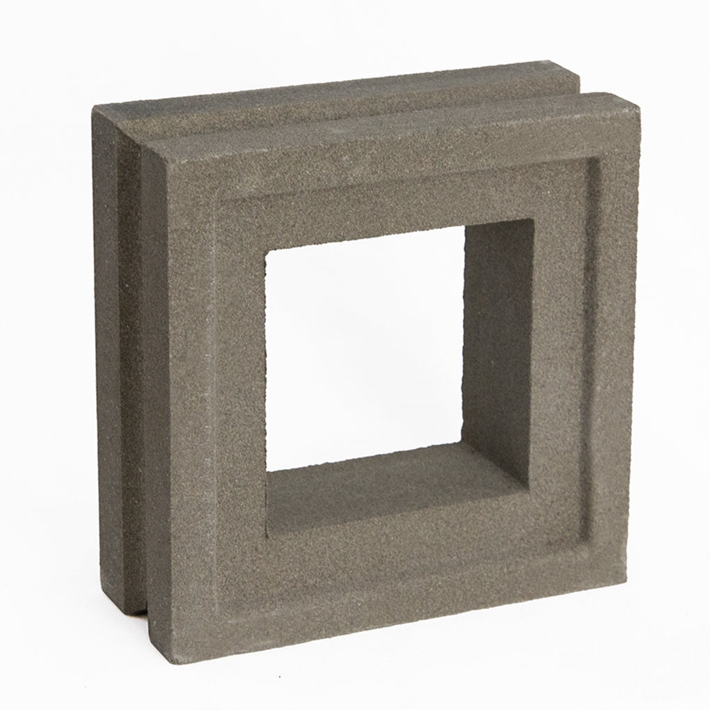 The Arbie Sample by New York Cement Tile is a gray concrete block with a square center, ideal for stylish privacy screens.
