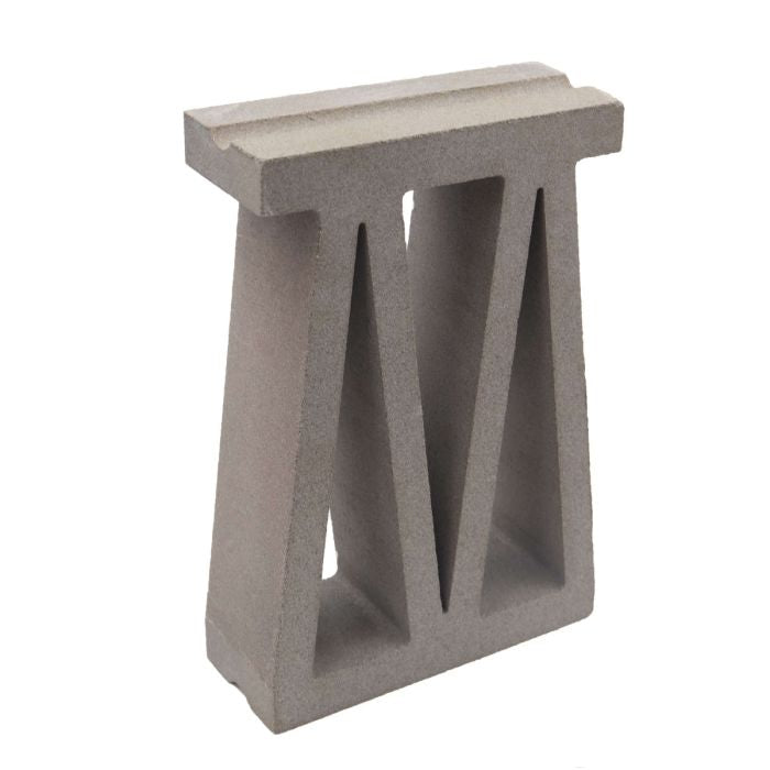 Bara, Sample by New York Cement Tile: a gray breeze block with a T-shaped top and two triangular openings.