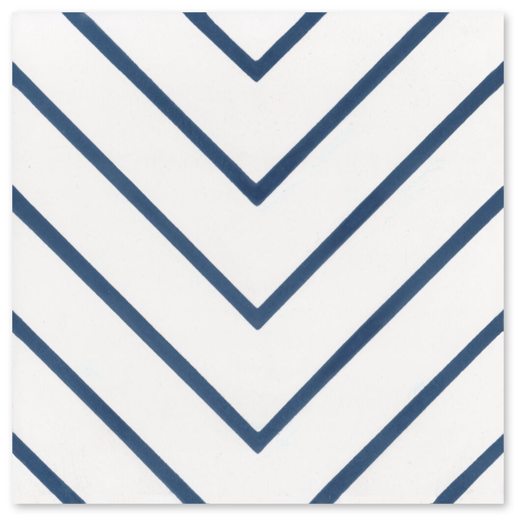 N20-437 Extra Sample by New York Cement Tile: White tile with bold dark blue chevron stripes in a repeating V pattern.