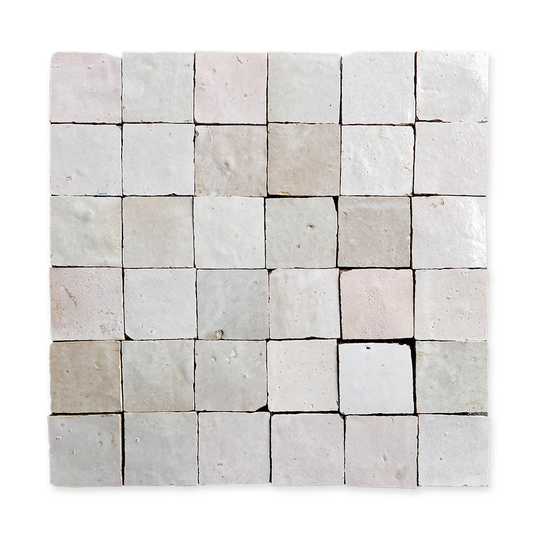 A 36-tile grid of Blushed Glazed Zellige by New York Cement Tile, each handcrafted with a textured, off-white finish.