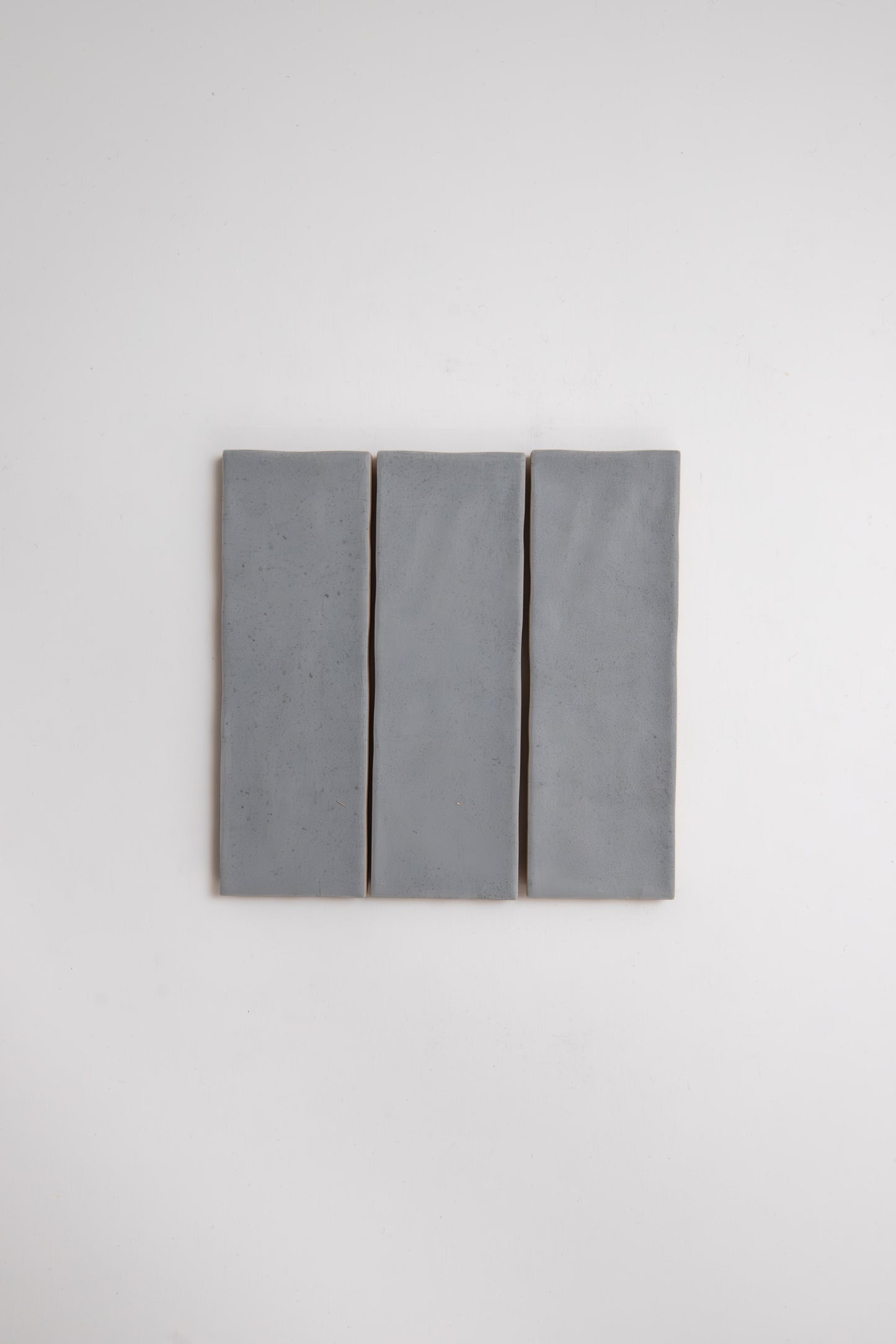 Three Bourton Dark Blue tiles by Cottage Ivy are aligned vertically side by side against a plain white background.