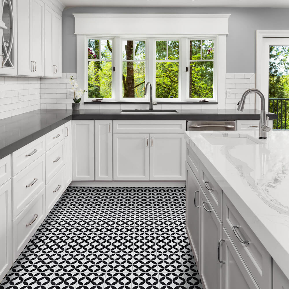 Modern kitchen with durable N20-061 White tiles by New York Cement Tile, gray counters, and large windows overlooking trees.
