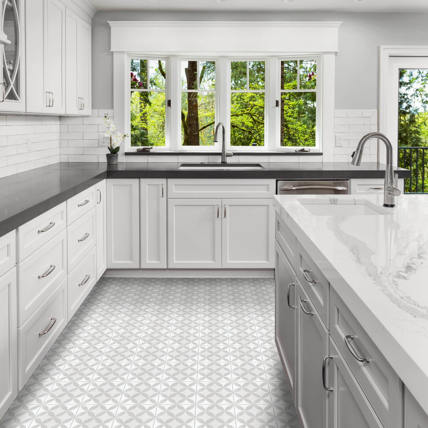 Modern white kitchen with N20-062 2245/6 cement tiles by New York Cement Tile and black countertops, large windows.