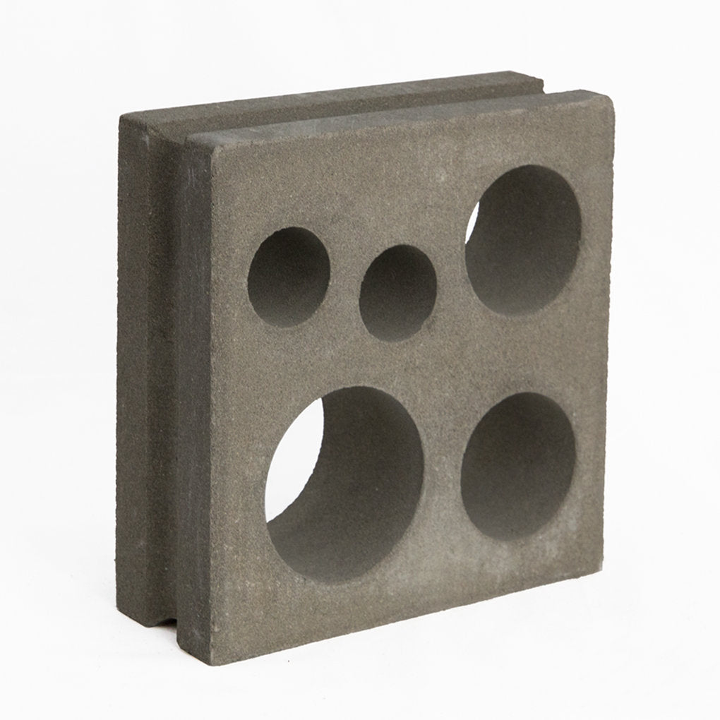 The Jami by New York Cement Tile is a square gray breeze block with five round holes, great for modern decorative walls.