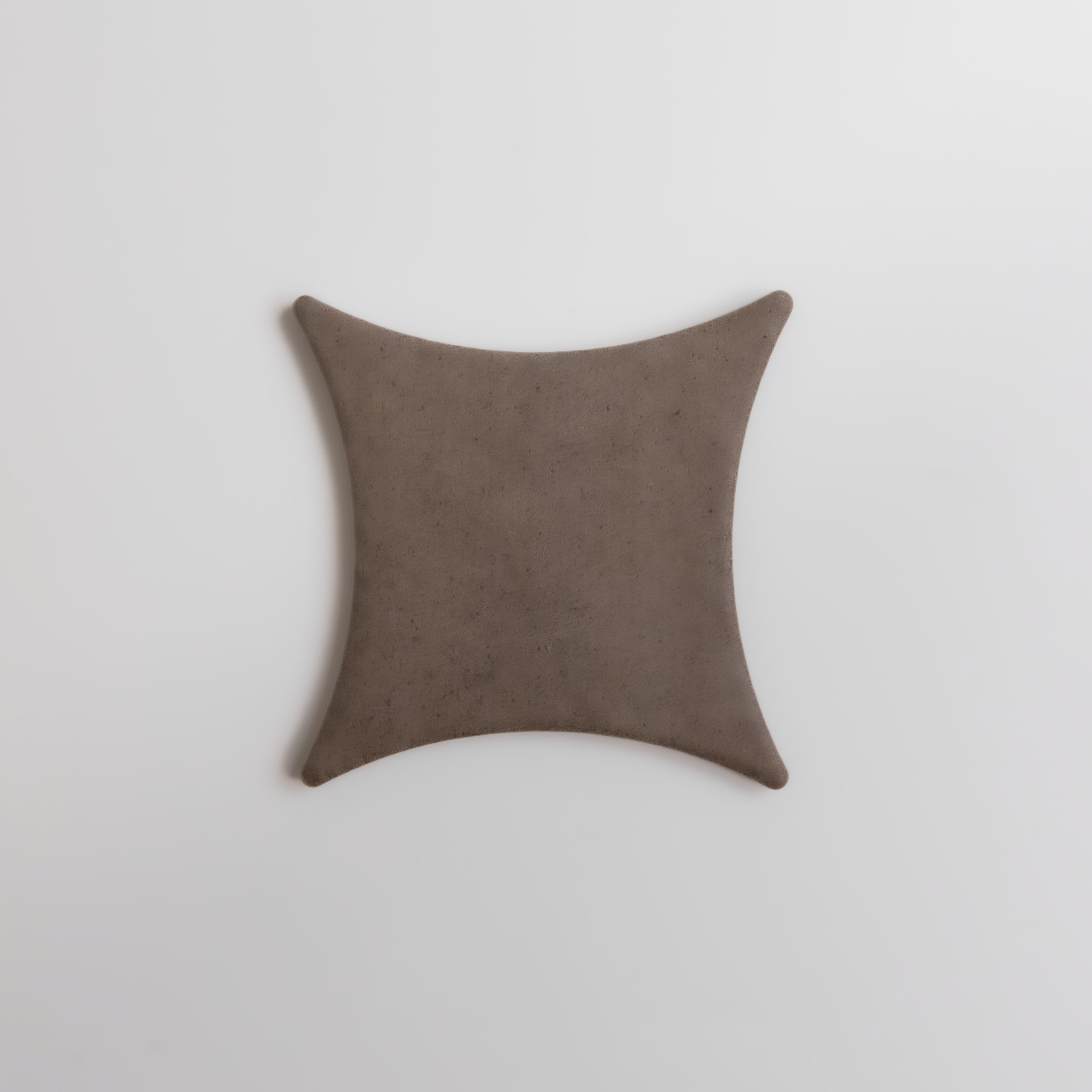 Brown square pillow on a light gray background