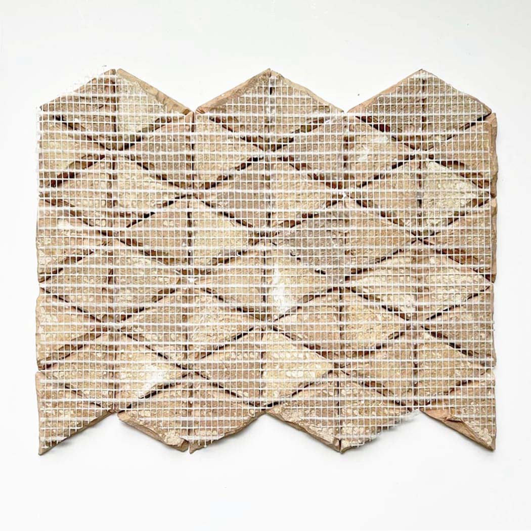 GLAZED ZELLIGE MOSAIC MAT TRIANGLES - Pearl Grey SHELL by New York Cement Tile features geometric tiles on white mesh.