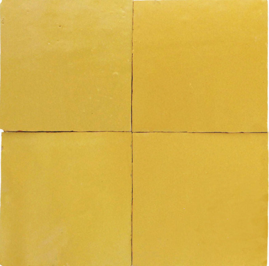 Four Sunflower Yellow Zellige tiles by New York Cement Tile, arranged in a square with visible grout lines.
