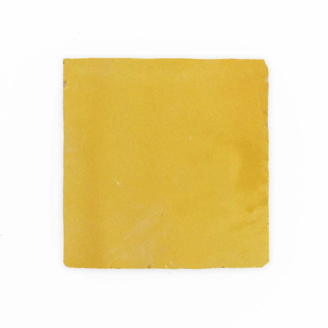 A single Sunflower Yellow 2X2 tile sample by New York Cement Tile on a plain white background.