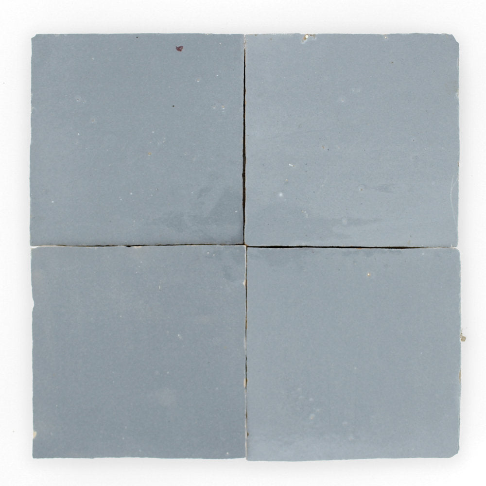 Four Steel Grey 2x2 tiles by New York Cement Tile, arranged in a 2x2 grid with slight gaps between them.