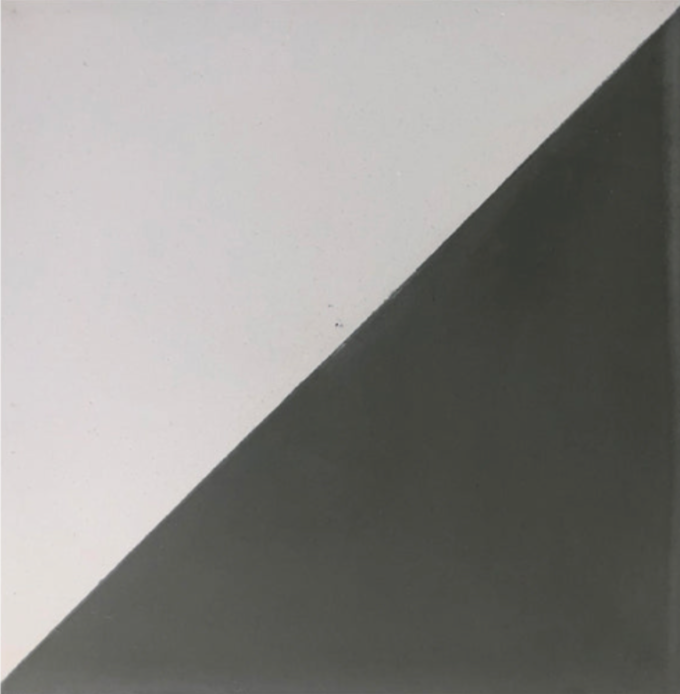 The N20-139 Extra Sample by New York Cement Tile is a square, split diagonally: top left white, bottom right dark gray.