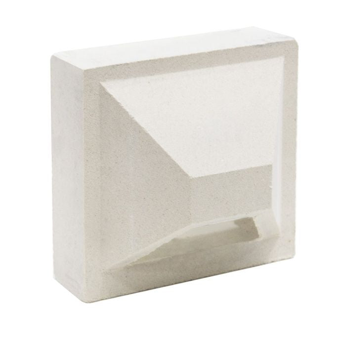 The Hawa Sample by New York Cement Tile is a white rectangular block with a geometric indent, perfect for modern partitions.
