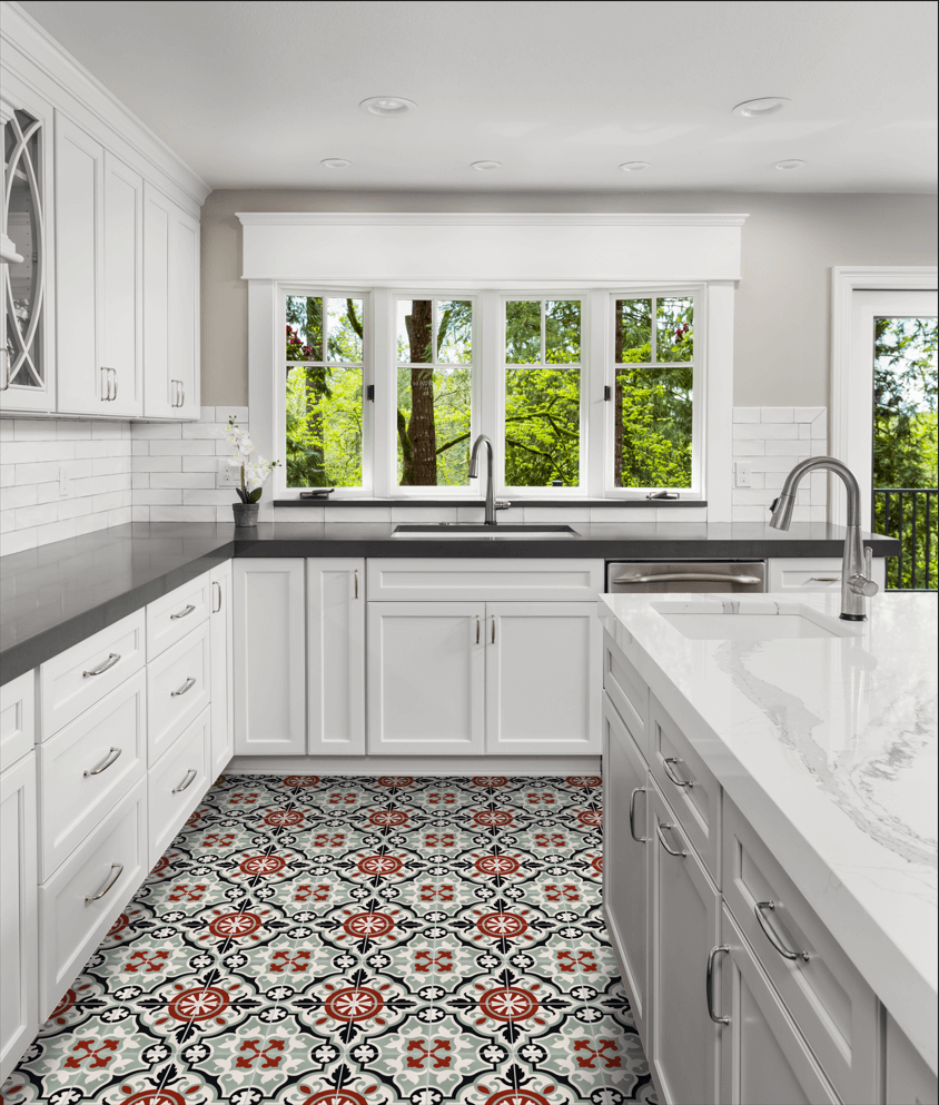 Bright kitchen with white cabinets, black counters, Vienna Bloom tiles by New York Cement Tile, and large windows to green views.