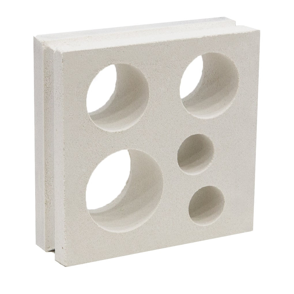 The Jami by New York Cement Tile is a white breeze block with six round holes, ideal for mid-century modern partitions.