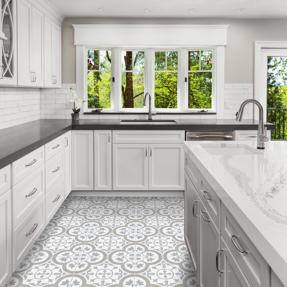 Bright kitchen with white cabinets, N20-045 Vintage Grey cement tiles by New York Cement Tile, and large windows.