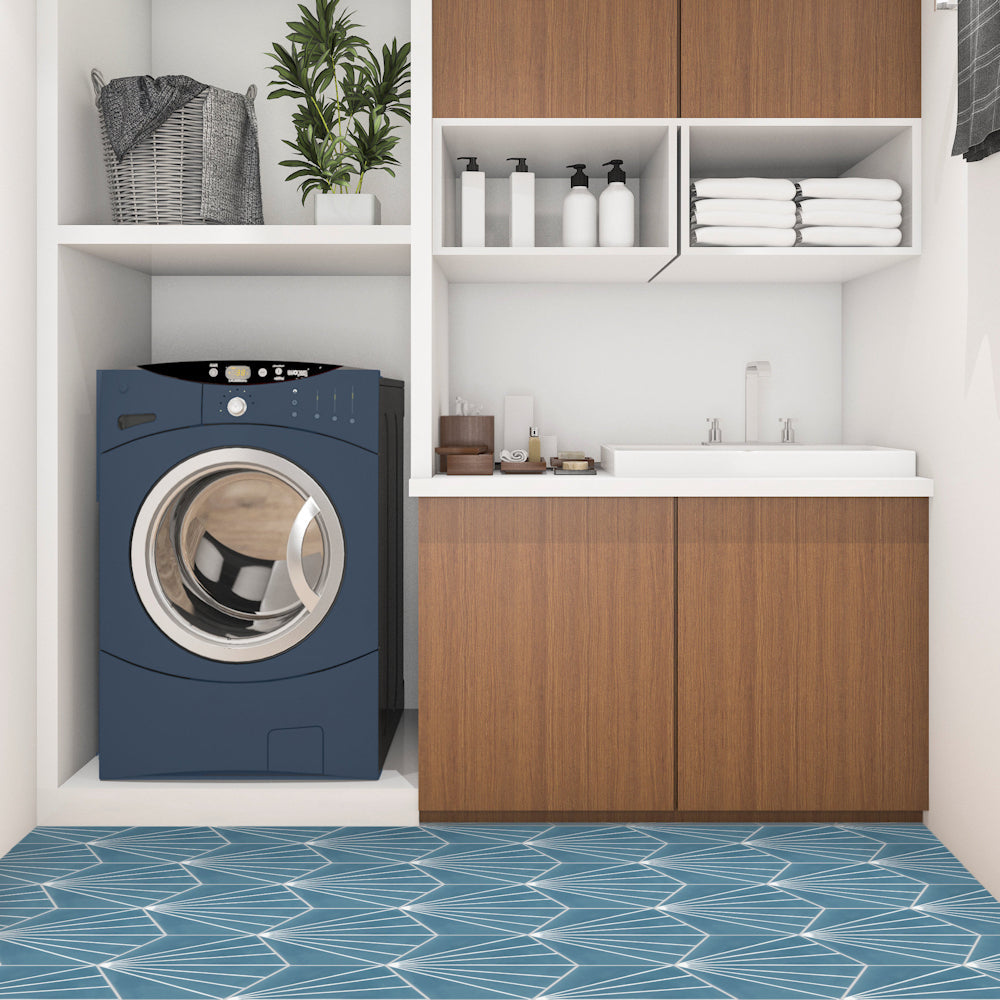 Modern laundry room featuring New York Cement Tile's NH23-036 - 4401, blue washer, sink, wood cabinets, and decor.