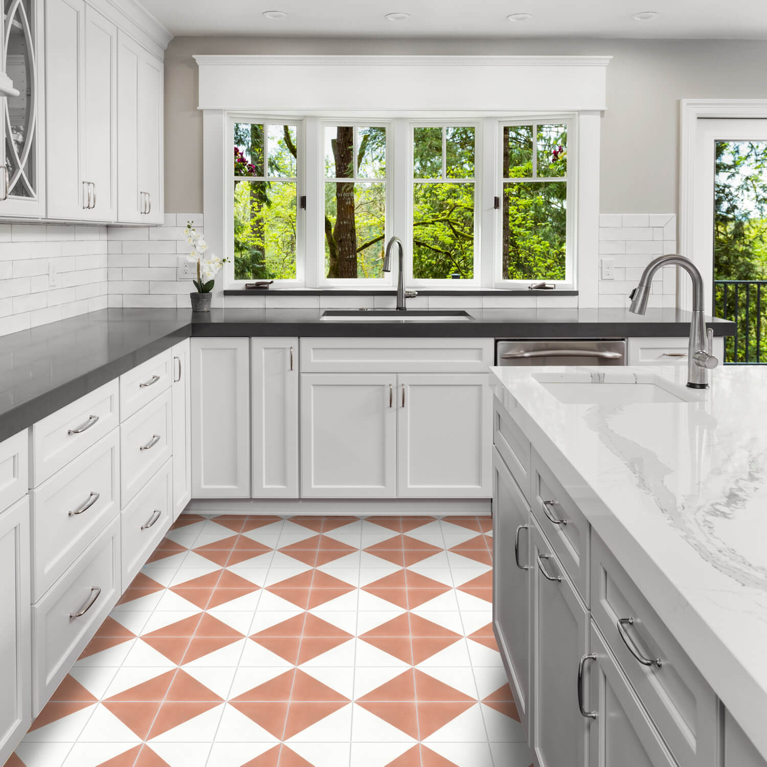 Bright kitchen with white cabinets, black countertops, large windows, and a white floor featuring N20-139 Misty Coral & White tiles by New York Cement Tile.