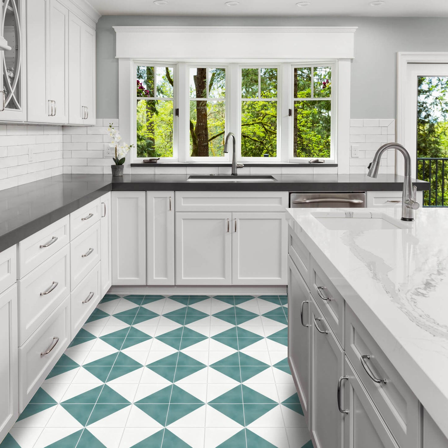 Bright kitchen with white cabinets, dark counters, and New York Cement Tile N20-139 Icy Lagoon & White cement tiles.