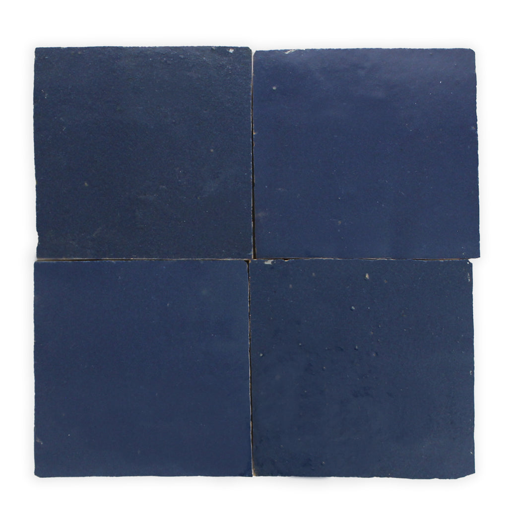 Four Navy Depths, Extra Sample tiles by New York Cement Tile arranged in a grid on a white background.