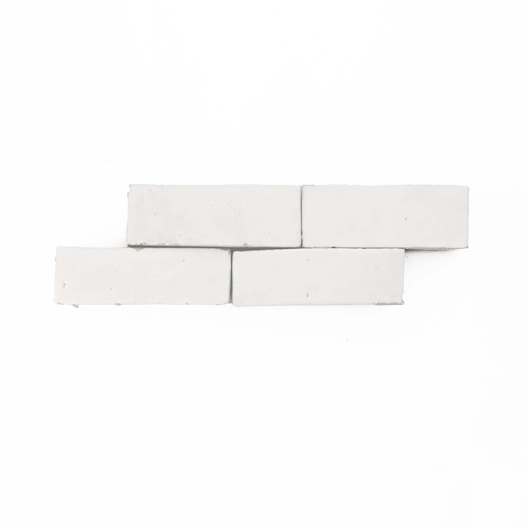 Four Ivory Cloud (2x6) tiles by New York Cement Tile, arranged staggered on a plain white background.